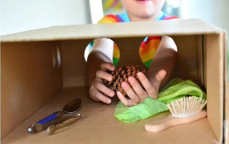 child playing Touch-and-Feel Box