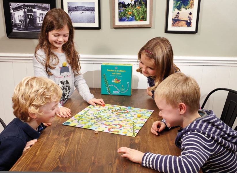 Kids playing snakes and ladders