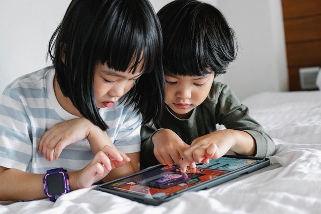 Two children playing one of the brain booster apps