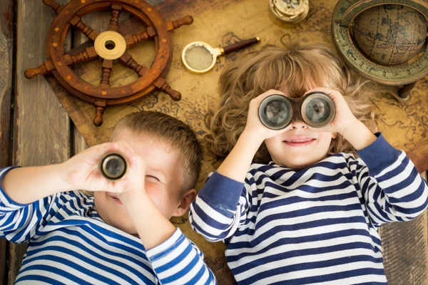 Two children looking into binoculars